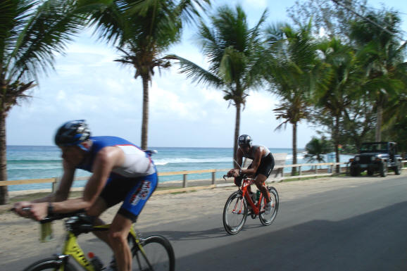 St. Croix Triathlon bike riders going through Cane Bay along the ocean.