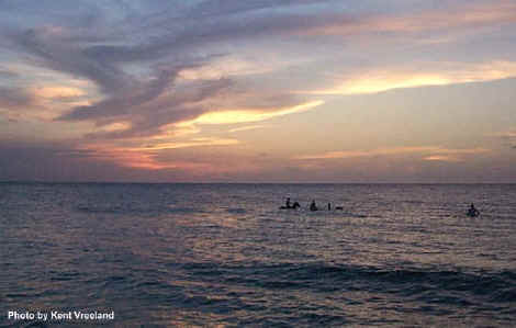 Riding horses in the ocean at sunset in Cane Bay, St. Croix.